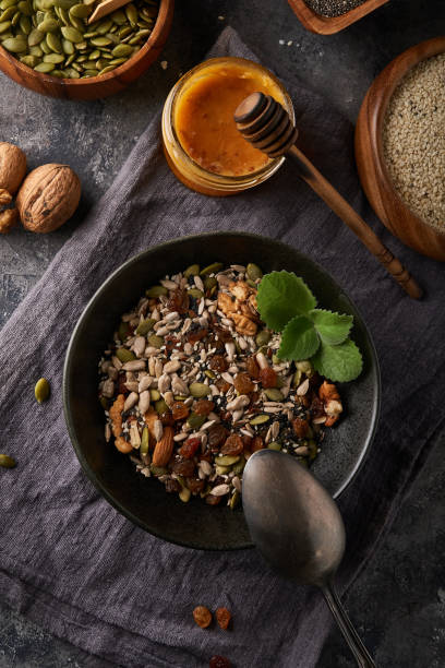 istock Healthy breakfast, seed and nut mix with honey and mint 1286157950