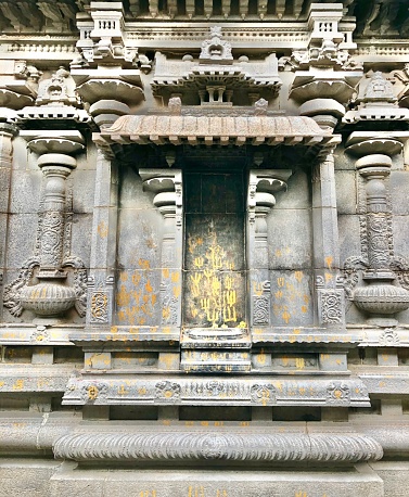 Bas relief stone carved exterior walls of historical temple in Tamilnadu.