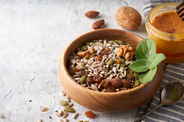 istock Healthy breakfast, seed and nut mix with honey and mint 1286158013