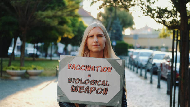 istock Young woman protesting against vaccination like biological weapon 1286160966