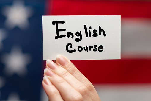 English course text on a card. American flag background.