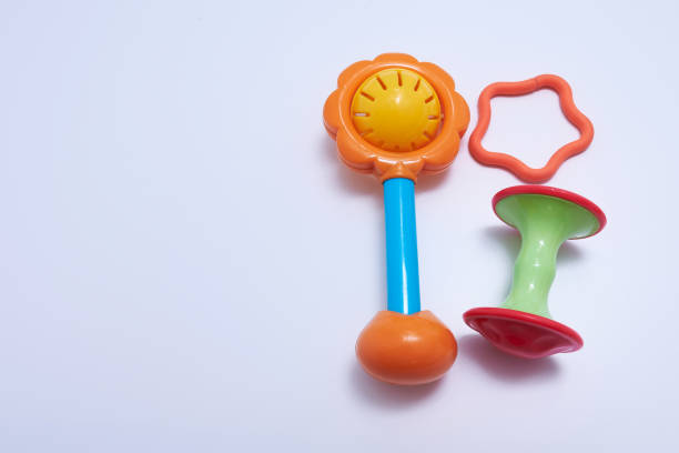 Plastic Retro Rattle. Baby toys on white background. Flat lay. Copy space.