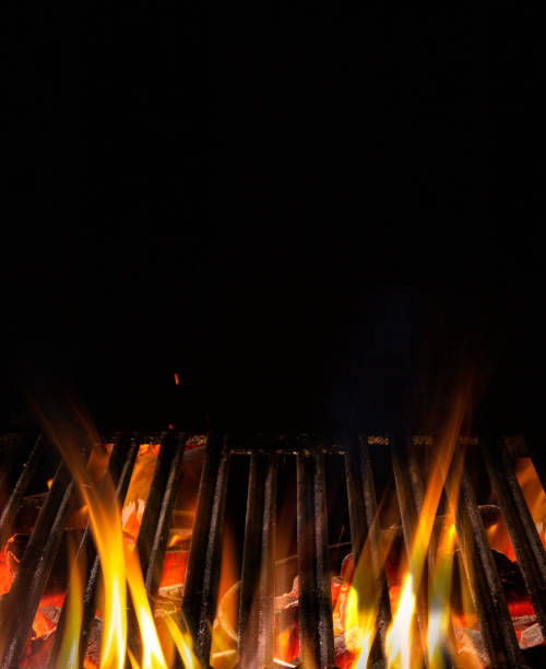 istock Empty flaming charcoal grill with open fire, ready for product placement. Concept of summer grilling, barbecue, bbq and party. Black copyspace 1286169354