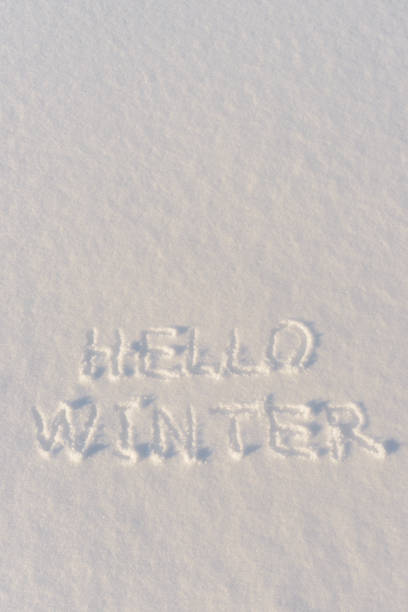 istock Text HELLO WINTER, written on fresh white snow with shining icy crystals in cold sunny day. Natural winter Christmas and New year holidays background or mock up with space for text 1286169736