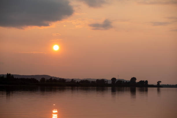evening landscape at sunset with trees and meadows