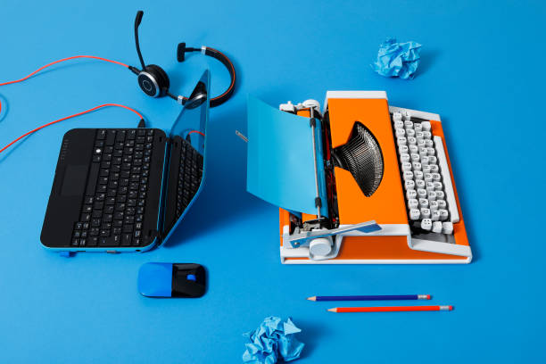 istock Digital and analog – Laptop and 70s Typewriter 1286174760