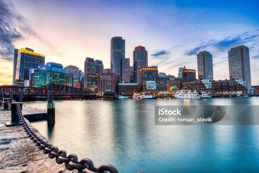 Boston Skyline with Financial District and Boston Harbor at Sunset, USA Boston - Massachusetts Stock Photo