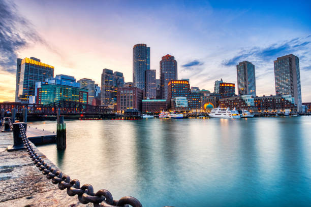boston skyline with financial district and boston harbor at sunset, usa - boston harbor imagens e fotografias de stock