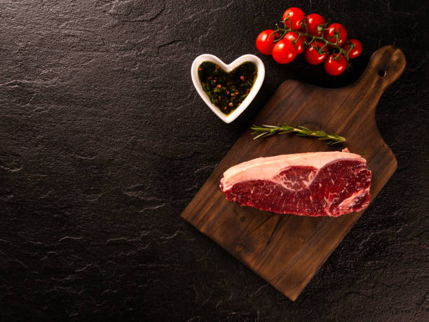 istock Fresh Picanha meat with ingredients for cooking on dark background, top view. 1286176367