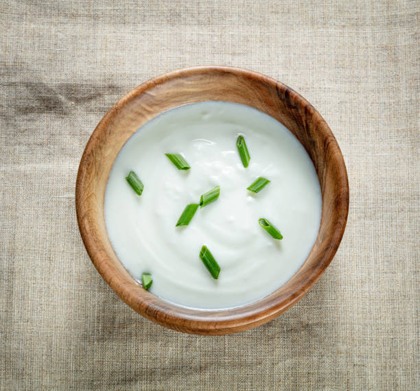 istock cream sour in wooden bowl on a canvas 1286179972