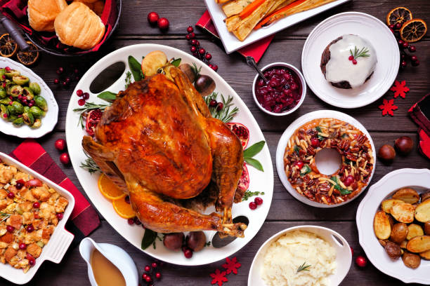 istock Traditional Christmas turkey dinner. Top view table scene on a dark wood background. 1286180164