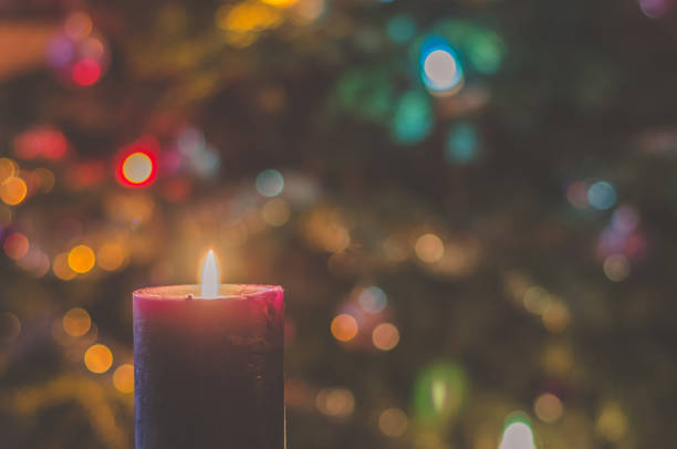 istock christmas festive concept with christmas tree lights and burning candle 1286182418
