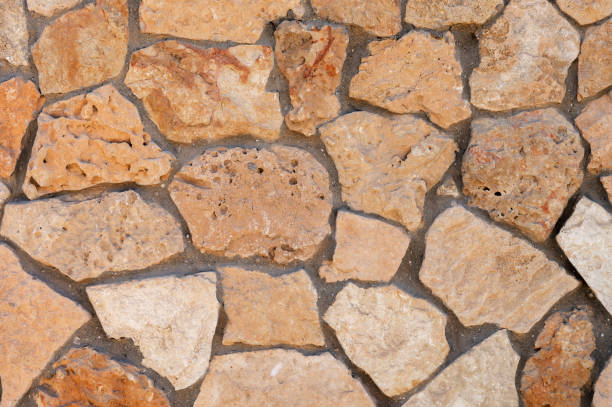 istock An uneven wall of decorative stacked cobblestones. Medieval background decorative insert 1286183382
