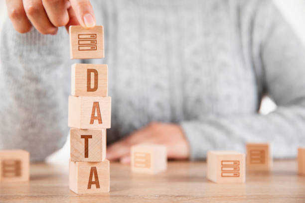 istock Woman is Writing Data Word with Wooden Cubes 1286184290