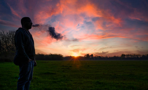 istock Man smoking outdoor at sunset 1286184340