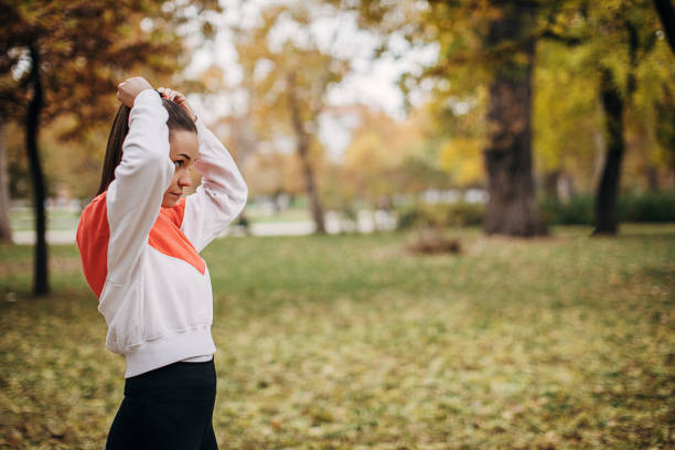 istock Beautiful young woman in park 1286185864