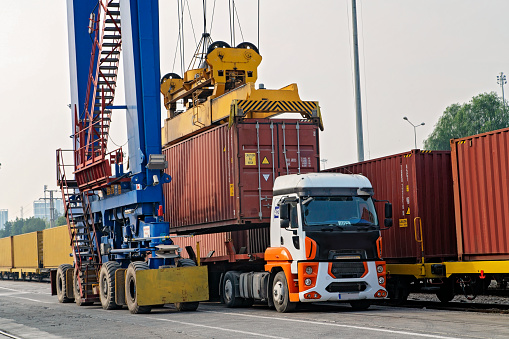 Crane lifting container and loading or unloading the freight train.