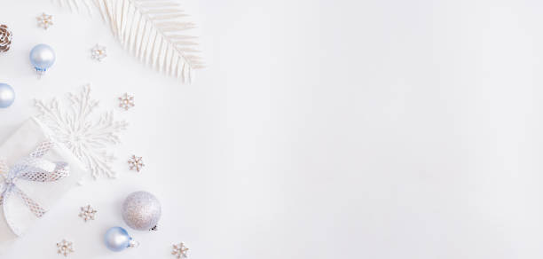 istock Flat lay frame with christmas baubles decoration and gift box on a white background 1286189225