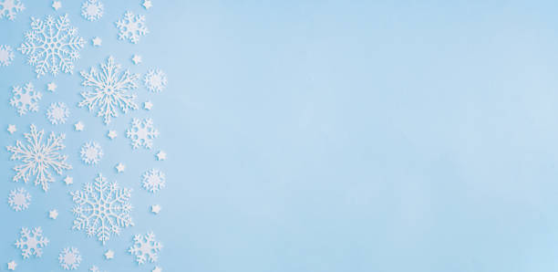 istock Flat lay christmas border with snowflakes on a blue background 1286189230