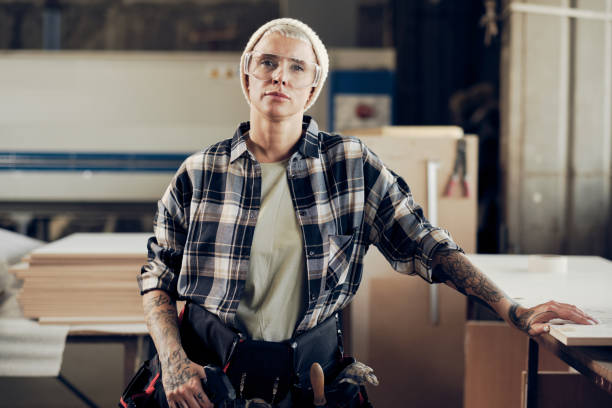 istock Female carpenter in protective wear at wok 1286190564