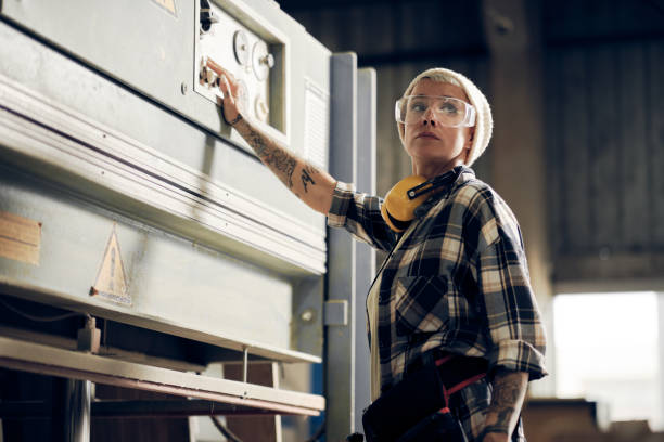 istock Female craftsman switching joiner machine 1286190567
