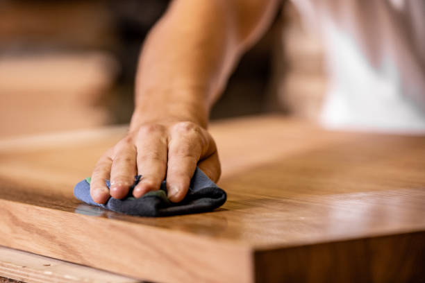 istock Young Carpenter Rubbing Oil Into Wood Meant For Table 1286190781