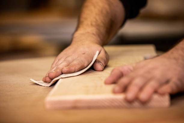 istock Hands of Carpenter Using Sand Paper on a Plank 1286190790