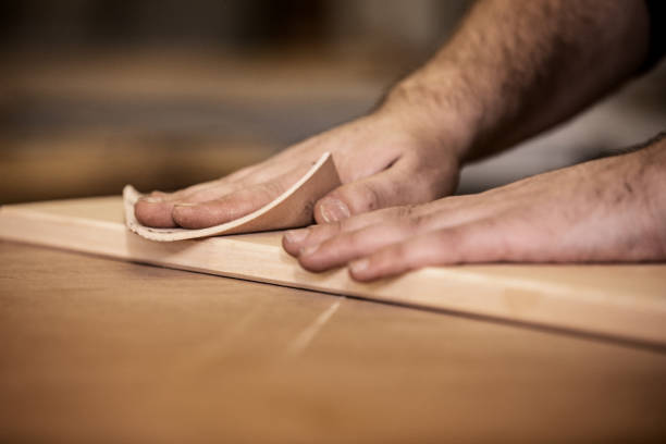 istock Close-up of Carpenter Using Sand Paper 1286190792