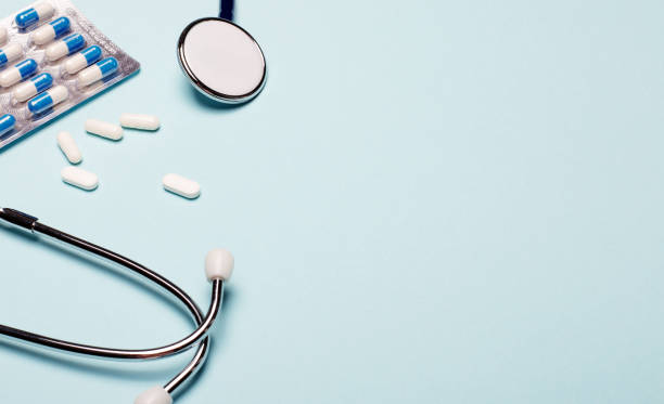 istock Pills and stethoscope on a light blue background. Copy space. Medical concept 1286192021