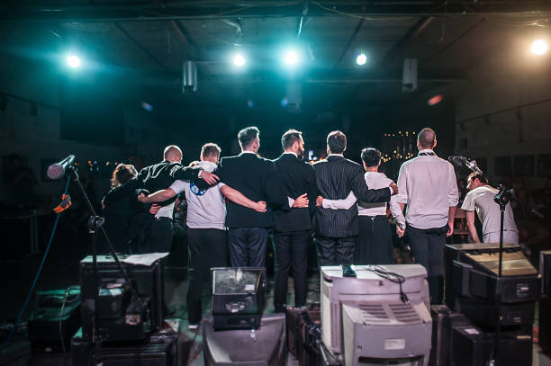 The silhouette of a rock band performing on stage.