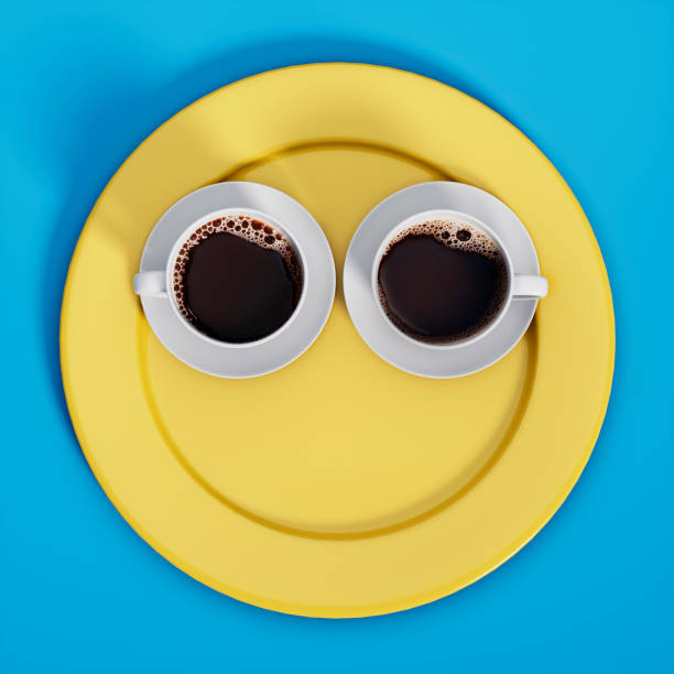 Two cups of fresh coffee on yellow plate with blue background