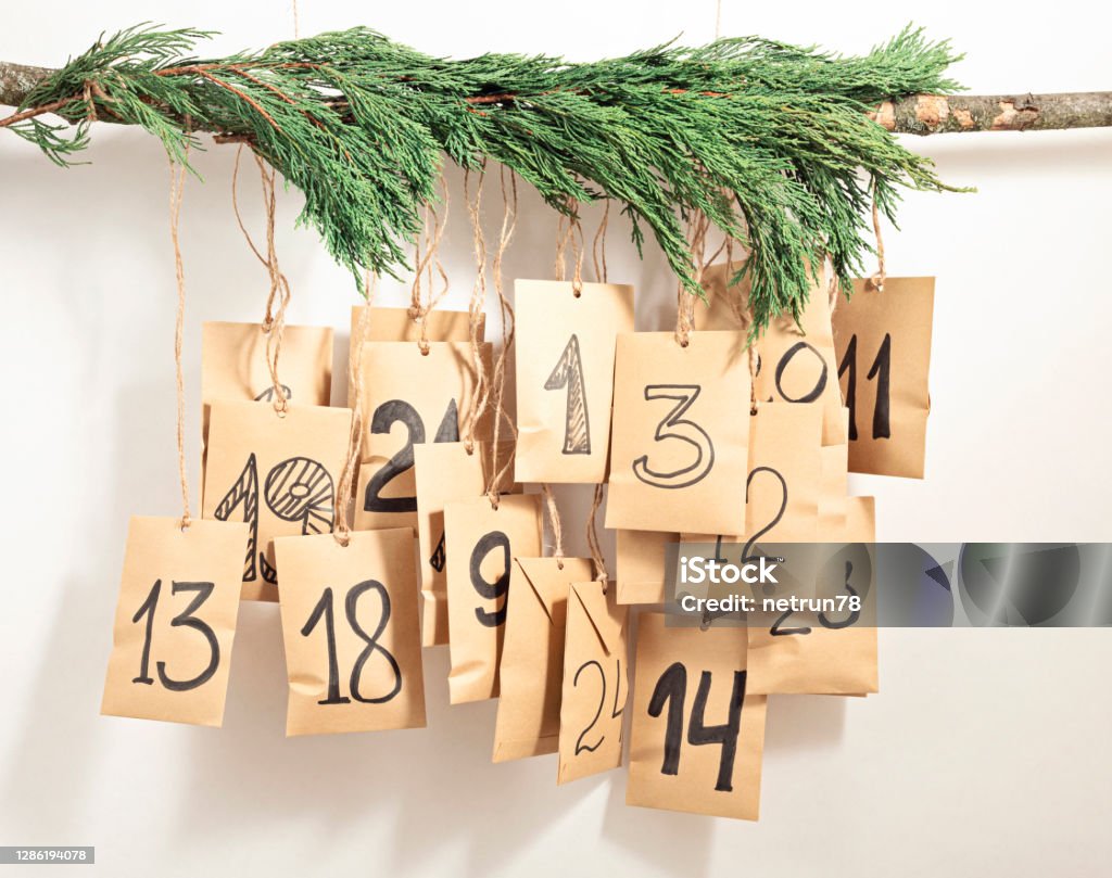 Handmade advent calendar. Gift bags hanging on the rope. Eco friendly Christmas gifts diy Handmade advent calendar. Gift bags hanging on the rope. Eco friendly Christmas gifts diy concept Advent Calendar Stock Photo