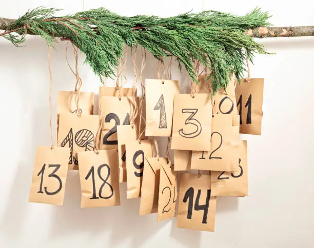 Handmade advent calendar. Gift bags hanging on the rope. Eco friendly Christmas gifts diy concept