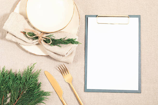 istock Christmas festive menu mockup scene. Empty plate and fir tree branches on linen table cloth in natural neutral colors 1286194080