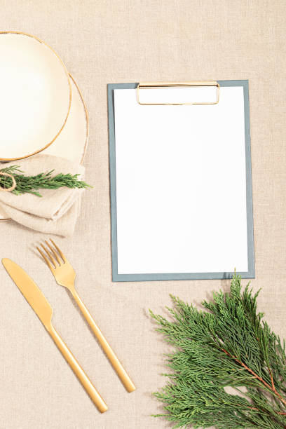 istock Christmas festive menu mockup scene. Empty plate and fir tree branches on linen table cloth in natural neutral colors 1286194129