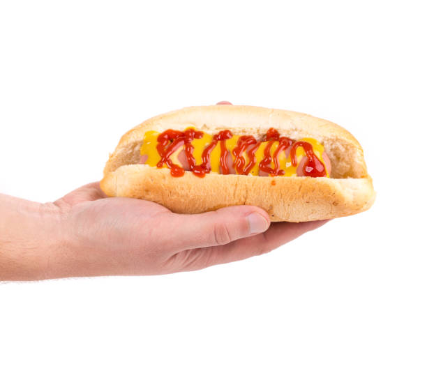 istock Hand holding hot dog. 1286195462