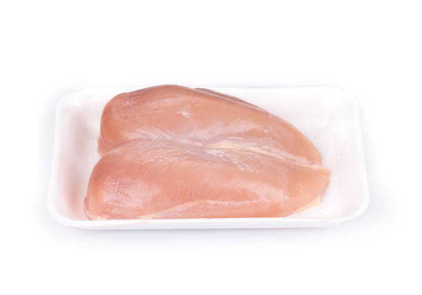 istock Raw chicken breast fillets on foam plastic trays. 1286195559