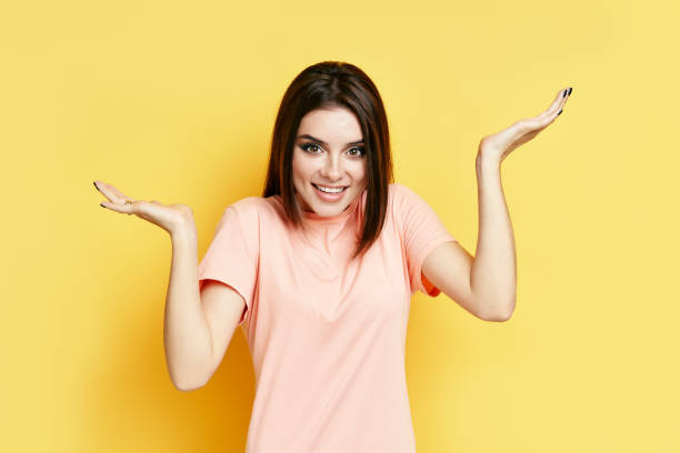 istock Smiling confused young woman having doubts on yellow background 1286195672