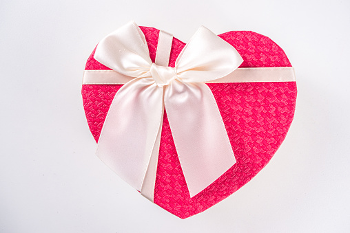 Valentine day Greeting background, heart shaped gift box with red ribbon bow, copy space for your text