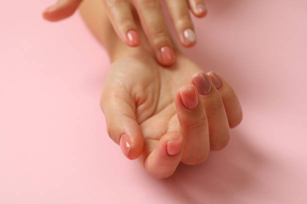 istock Cute female hands on pink background, close up 1286201014