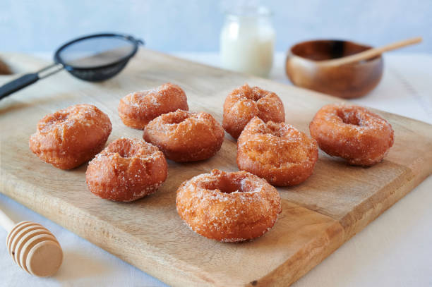 istock Freshly baked homemade donuts on a wooden board 1286201211