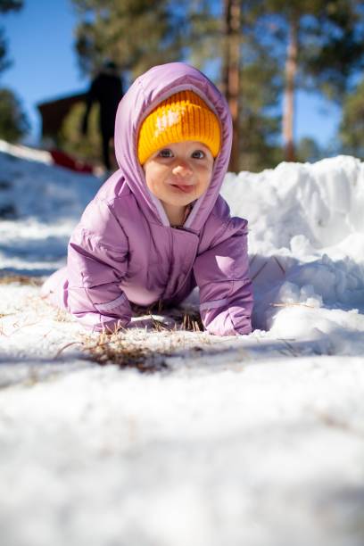 istock Infant Girl playing in snow 1286201967