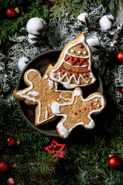 istock Christmas gingerbread cookies with icing ornate. Xmas decorations, dark background. Top view 1286202103