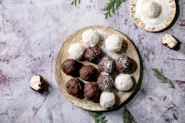 istock Raw vegan coconut chocolate candy balls over white. Flat lay 1286202107