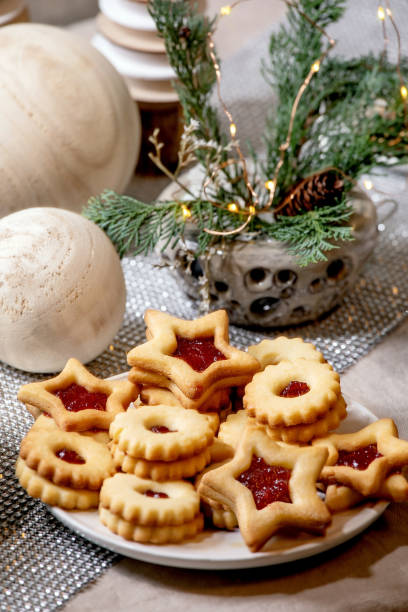 istock Christmas Linz shortbread biscuits cookies with wooden decorations on xmas table 1286202122
