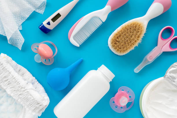 istock Children's accessories and cosmetics on a blue background, flat lay, top view, layout. The concept of hygiene of the baby. A set of tools to care for a newborn, background 1286203594