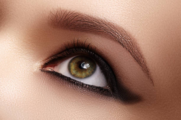 istock Closeup Female Eye with Dark Make-up, great Shapes Brows. Celebrate Makeup, Luxury Eyeshadows. Fashion Eyeliner, pencil 1286205247