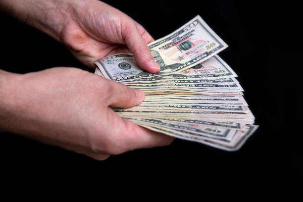 istock Hand Holding Money 1286206058