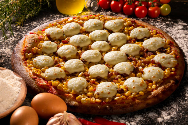 istock Various vegetables at wooden rustic background with copyspace on round pizza desk. Set of fresh vegetables. Egg, tomatoes, pepper, lettuce, onion, garlic, onion. Pizza ingredients. 1286206249