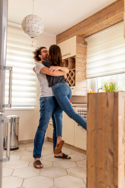istock Couple kissing in the kitchen 1286206692